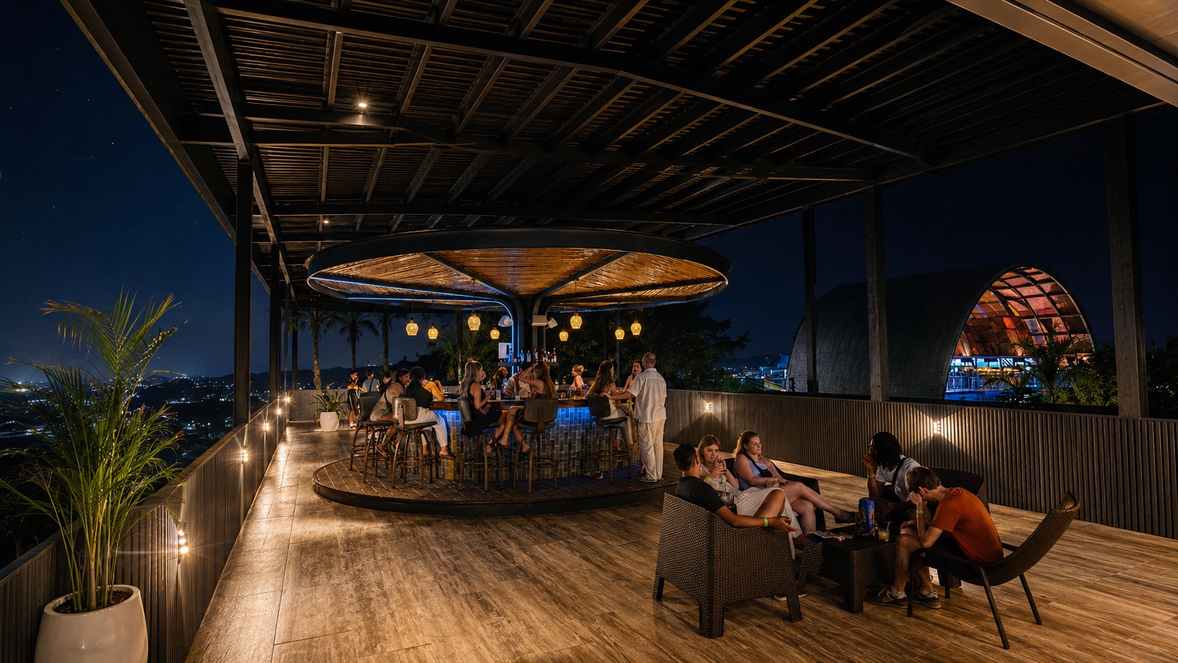 Travelers enjoying the rooftop bar at night in La Fortuna